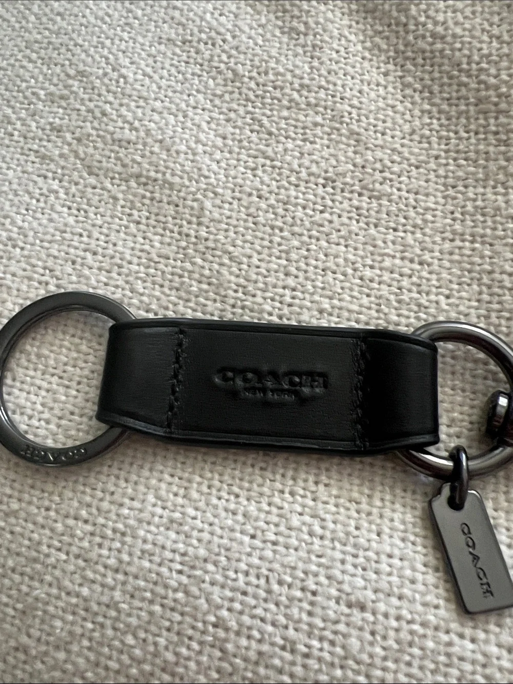 Coach Trigger Snap Key Fob black leather and silver-toned hardware.